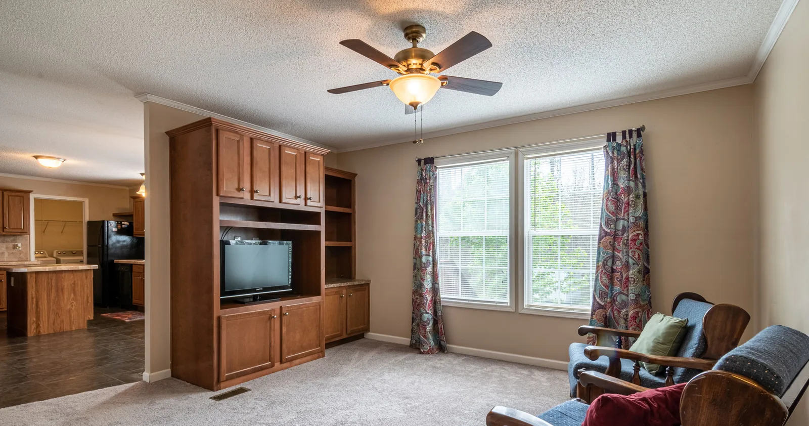 Living room with a ceiling fan and light kit
