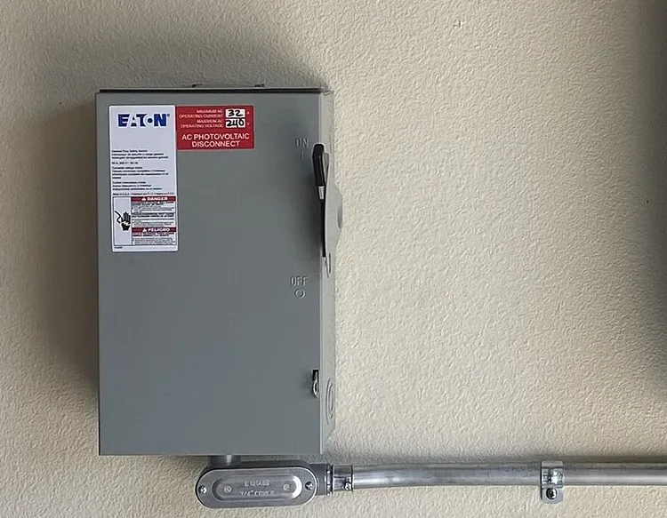 Labeled solar AC disconnect switch on a wall