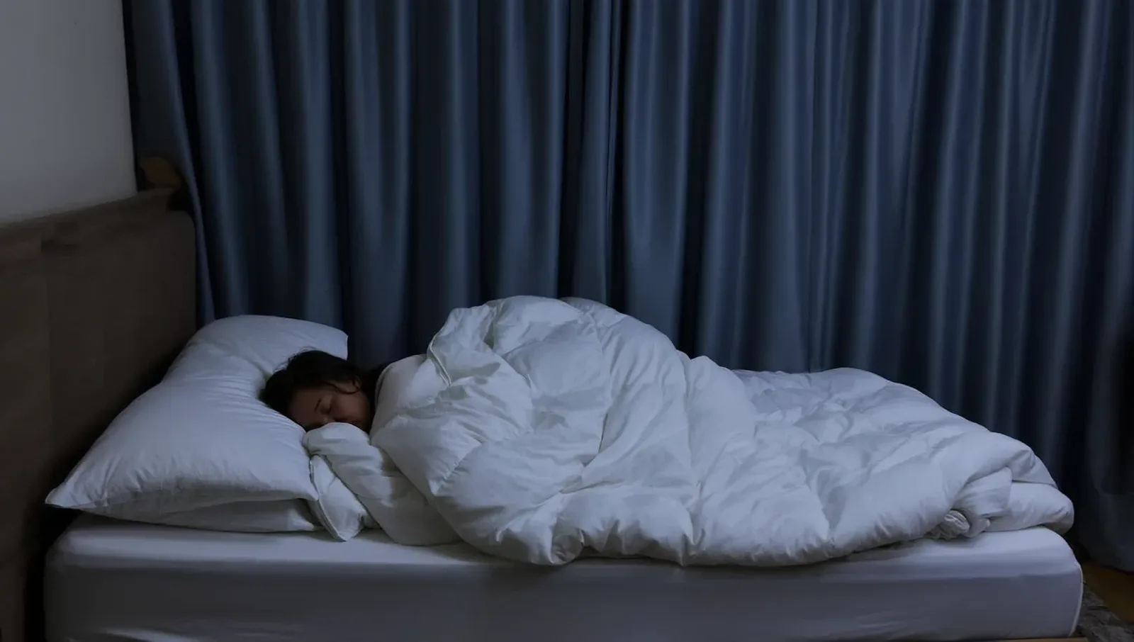 Person asleep under a thick comforter