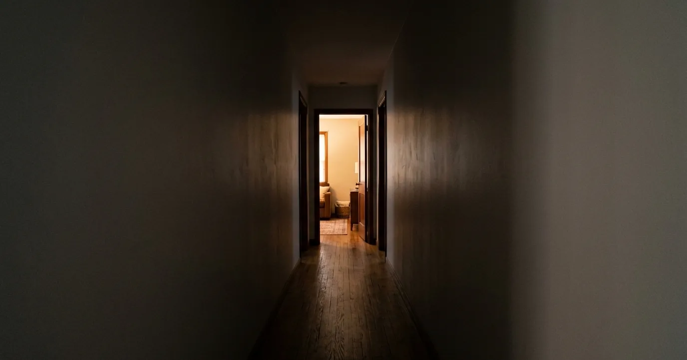 Empty home hallway leading to an open doorway