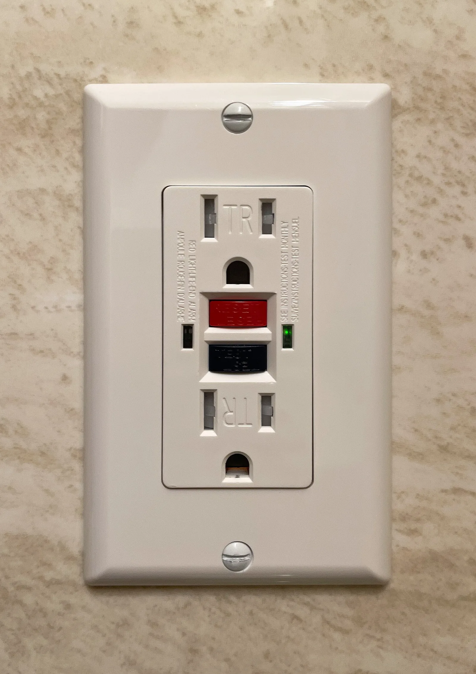 A North American residential GFCI receptacle with a red RESET button, a black TEST button, and a green status light.