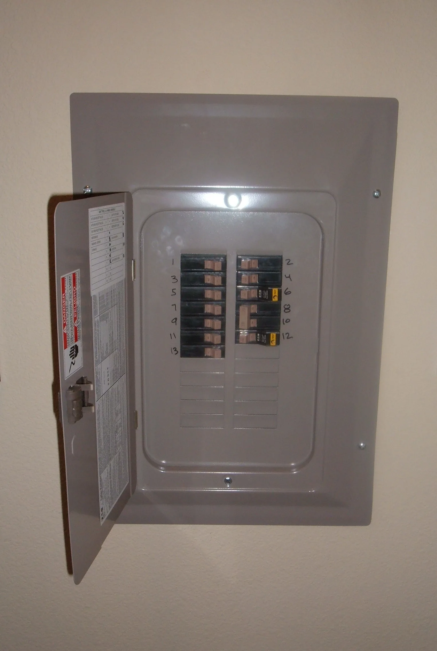 Open household breaker panel with numbered circuits